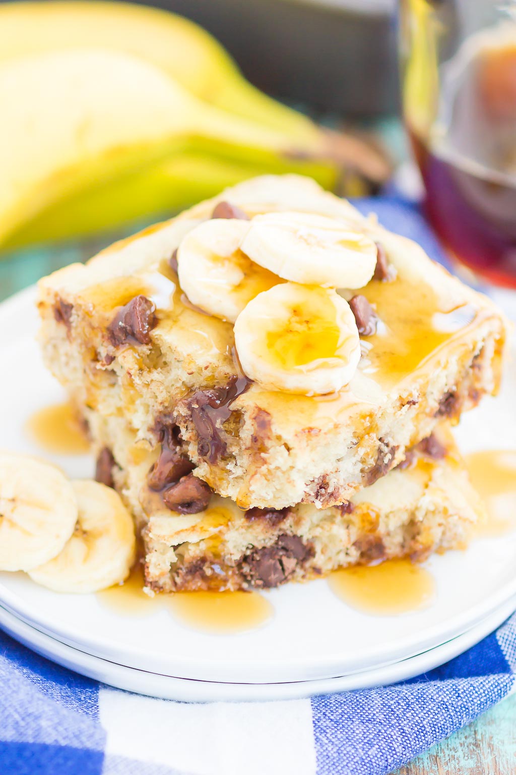 two squares of sheet pan banana chocolate chip pancakes on white plate