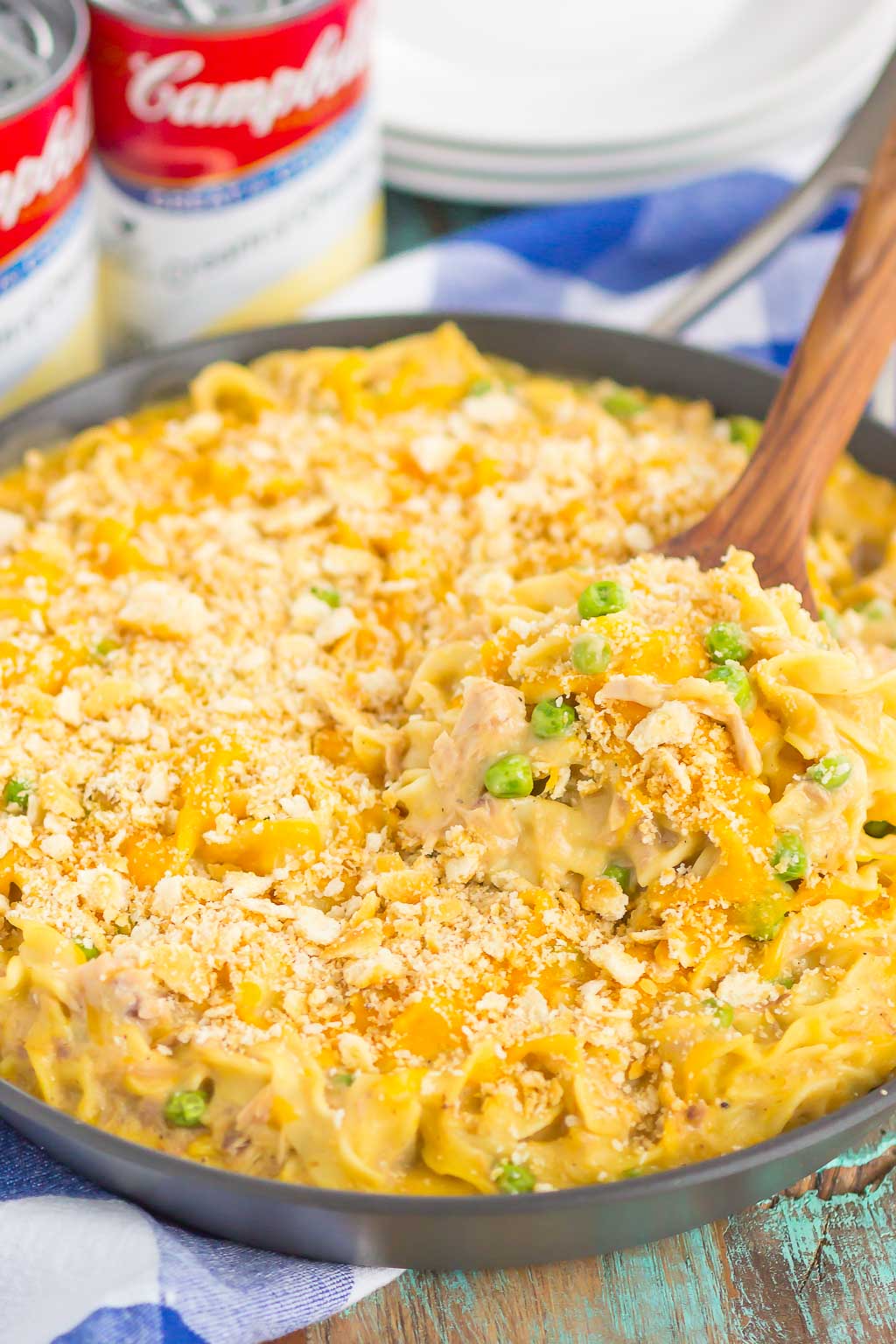 stovetop tuna noodle casserole in a large skillet with a wood spoon sticking out