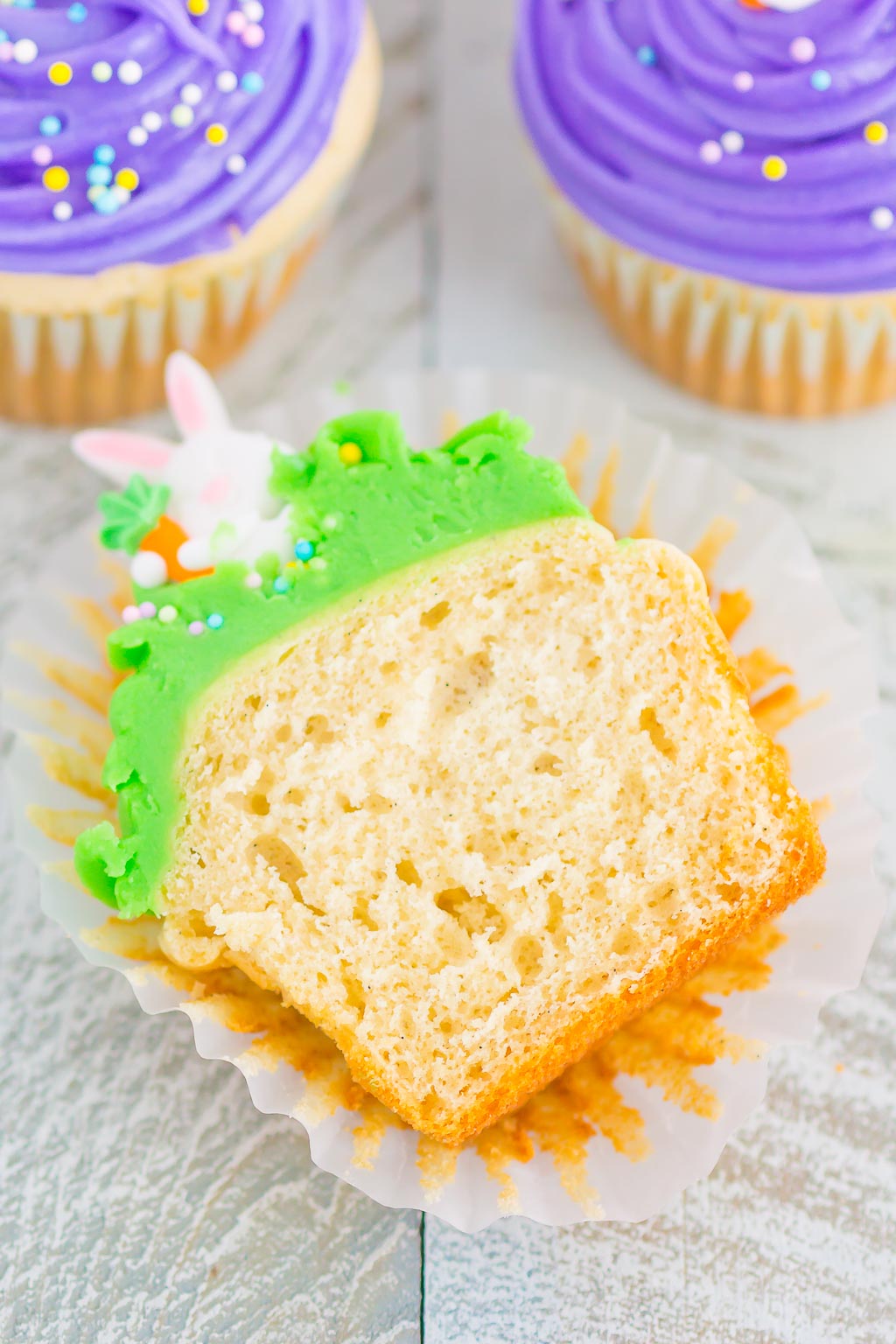 Half of a bunny cupcake laying on its side in a cupcake liner 