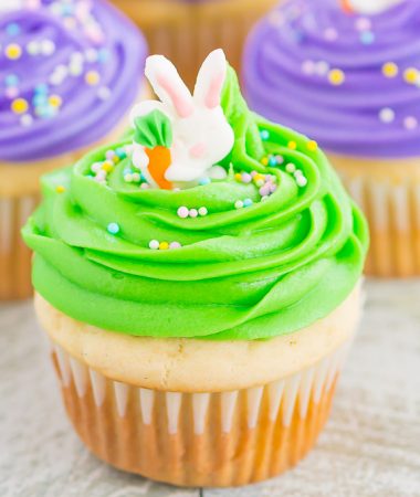 Easter Bunny Cupcakes are an easy and festive dessert to make for spring. A soft and moist yellow cupcake batter is baked until golden and then topped with a simple frosting, pastel sprinkles and a candy bunny. Fun, fast, and flavorful, these adorable cupcakes are perfect for Easter!