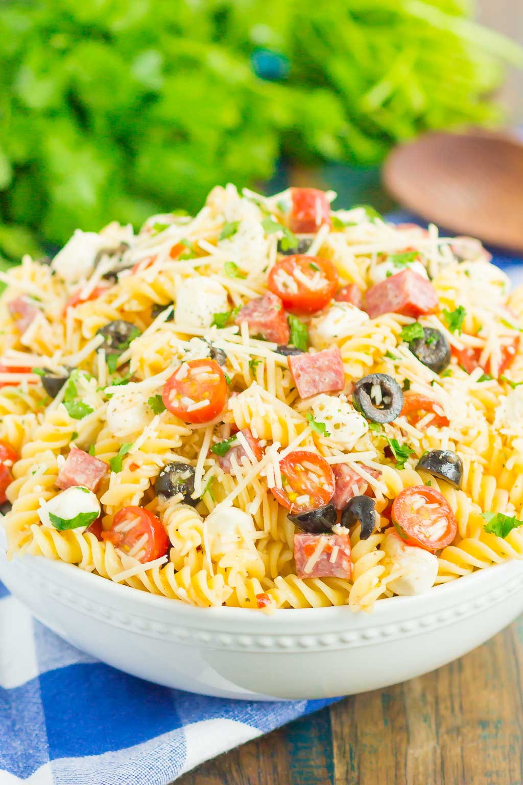 Easy Italian Pasta Salad is fast, fresh, and loaded with flavor. This zesty salad is packed with classic favorites, like salami, mozzarella pearls, black olives, cherry tomatoes and then tossed in a simple Italian dressing. Easy to make and ready in less than 30 minutes, this salad is perfect to serve for those summer parties and get-togethers! #pastasalad #italianpastasalad