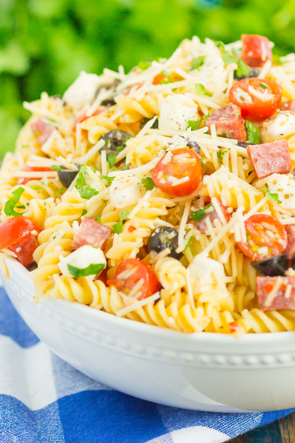 Easy Italian Pasta Salad is fast, fresh, and loaded with flavor. This zesty salad is packed with classic favorites, like salami, mozzarella pearls, black olives, cherry tomatoes and then tossed in a simple Italian dressing. Easy to make and ready in less than 30 minutes, this salad is perfect to serve for those summer parties and get-togethers! #pastasalad #italianpastasalad