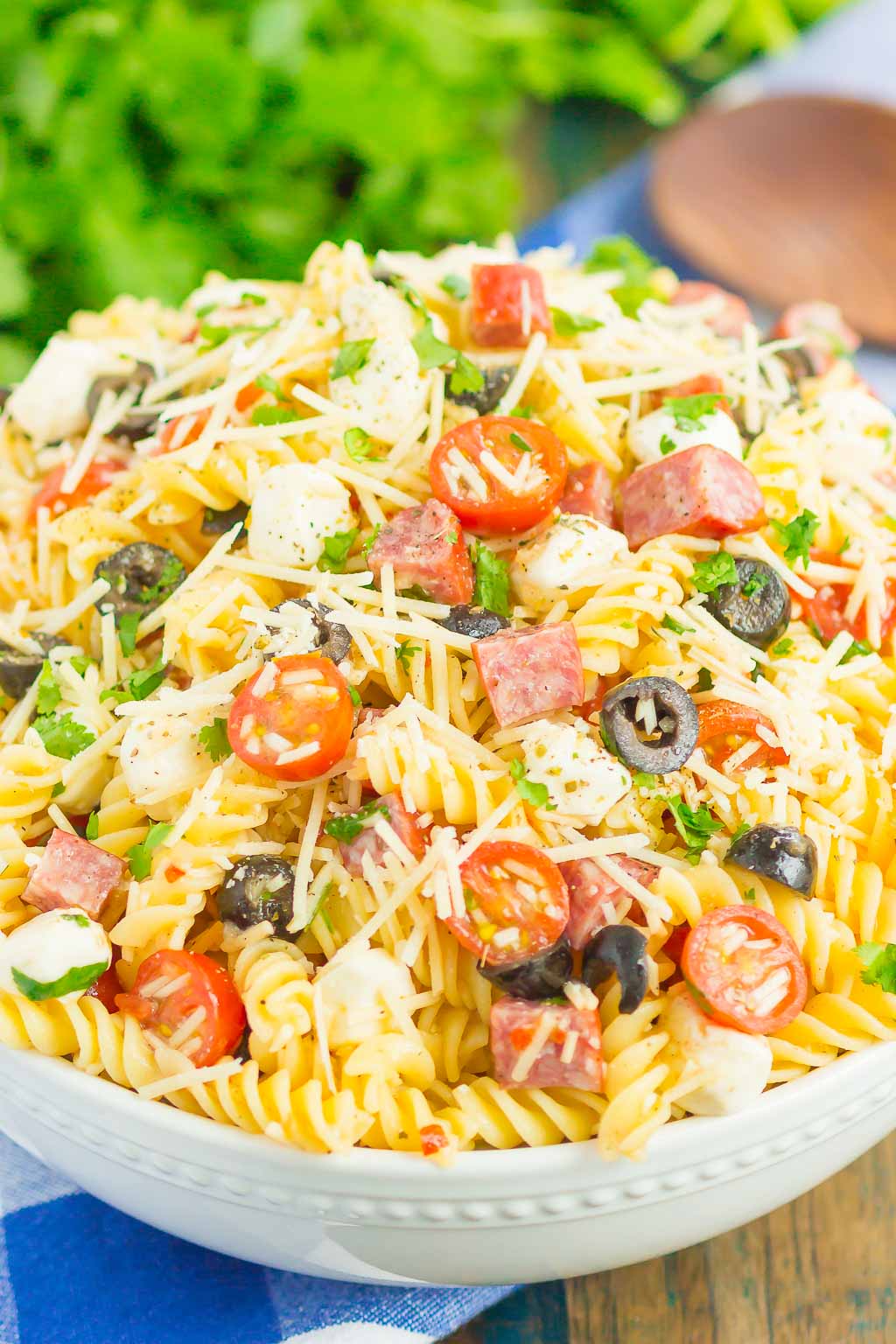Easy Italian Pasta Salad is fast, fresh, and loaded with flavor. This zesty salad is packed with classic favorites, like salami, mozzarella pearls, black olives, cherry tomatoes and then tossed in a simple Italian dressing. Easy to make and ready in less than 30 minutes, this salad is perfect to serve for those summer parties and get-togethers! #pastasalad #italianpastasalad