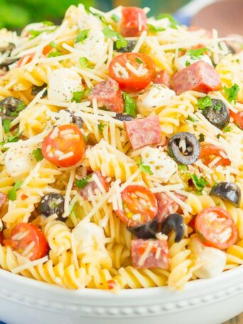 Easy Italian Pasta Salad is fast, fresh, and loaded with flavor. This zesty salad is packed with classic favorites, like salami, mozzarella pearls, black olives, cherry tomatoes and then tossed in a simple Italian dressing. Easy to make and ready in less than 30 minutes, this salad is perfect to serve for those summer parties and get-togethers!
