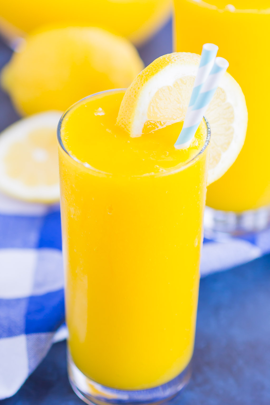 Frozen Mango Lemonade is a delicious way to beat the summer heat. With just four ingredients and ready in less than 5 minutes, you'll love the cool and creamy flavor of sweet mango and tart lemons! #lemonade #frozenlemonade #mangolemonade