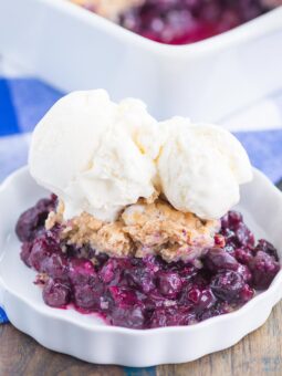 Easy Blueberry Cobbler is simple dessert that's ready in no time. Tangy blueberries are tossed with cozy spices and then sprinkled with a buttery, cinnamon sugar cake-like topping. Easy to make and loaded with flavor, this cozy cobbler is perfect to enjoy all year long!