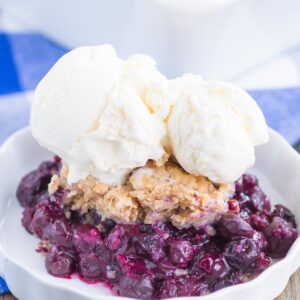 Easy Blueberry Cobbler is simple dessert that's ready in no time. Tangy blueberries are tossed with cozy spices and then sprinkled with a buttery, cinnamon sugar cake-like topping. Easy to make and loaded with flavor, this cozy cobbler is perfect to enjoy all year long!