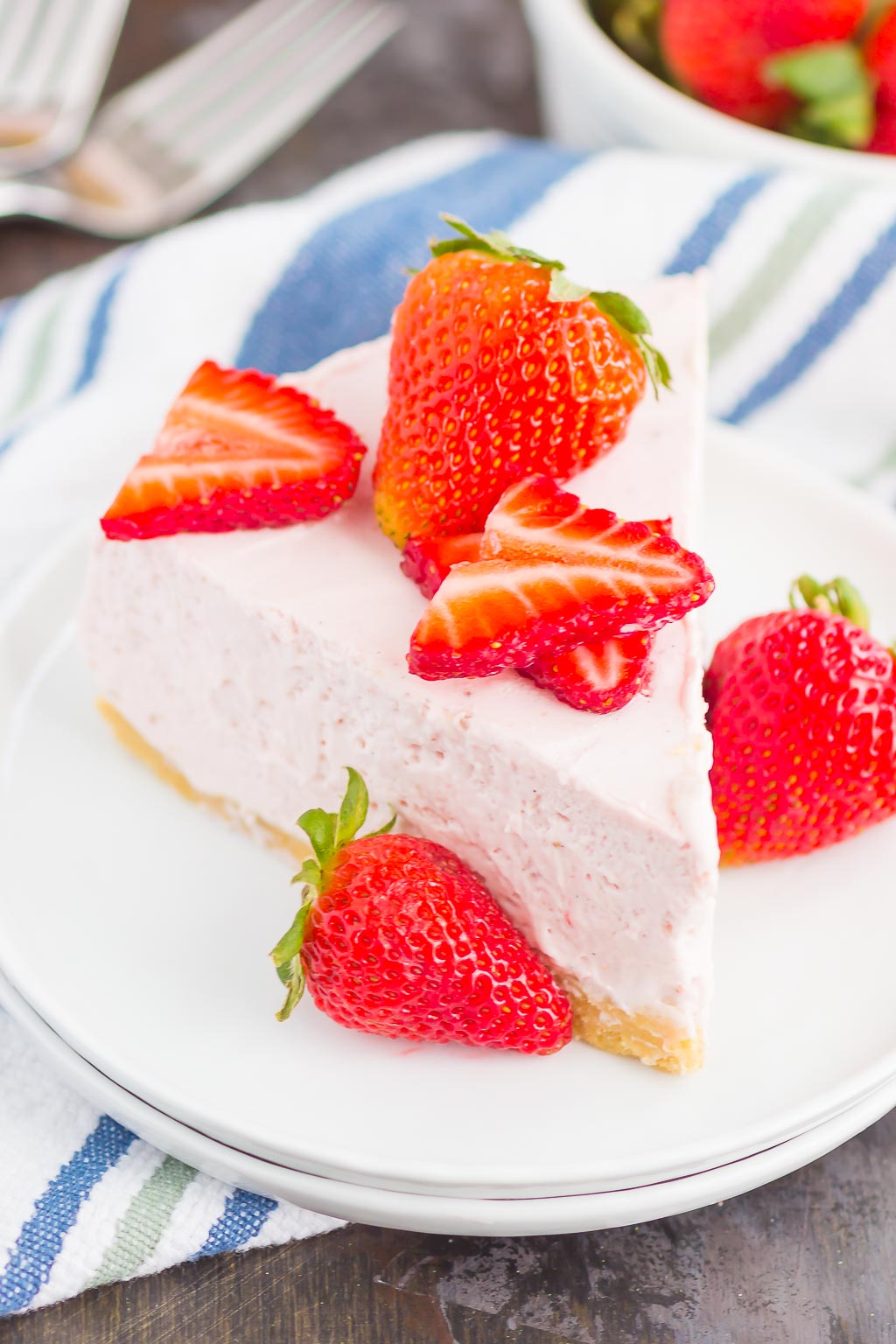 No Bake Strawberry Cheesecake is a simple dessert that's perfect for summer. A golden cookie crust is topped with a creamy strawberry cheesecake filling and then chilled to perfection. Easy to make and with no oven required, this decadent cake makes the most delicious treat!
