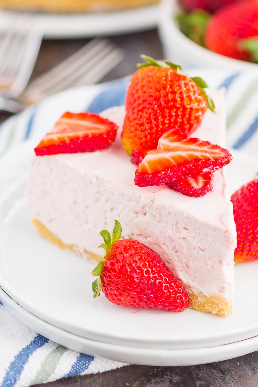 No Bake Strawberry Cheesecake is a simple dessert that's perfect for summer. A golden cookie crust is topped with a creamy strawberry cheesecake filling and then chilled to perfection. Easy to make and with no oven required, this decadent cake makes the most delicious treat!