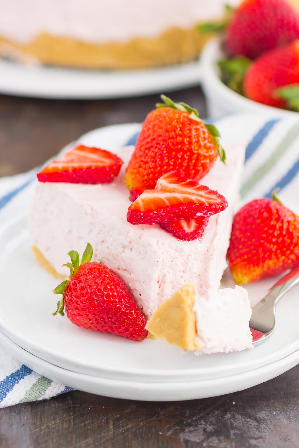 No Bake Strawberry Cheesecake is a simple dessert that's perfect for summer. A golden cookie crust is topped with a creamy strawberry cheesecake filling and then chilled to perfection. Easy to make and with no oven required, this decadent cake makes the most delicious treat!