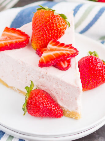 No Bake Strawberry Cheesecake is a simple dessert that's perfect for summer. A golden cookie crust is topped with a creamy strawberry cheesecake filling and then chilled to perfection. Easy to make and with no oven required, this decadent cake makes the most delicious treat!