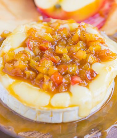 Caramel Apple Baked Brie is an easy appetizer that's ready in just 10 minutes. Fresh apples are sautéed in a buttery brown sugar mixture, drizzled with caramel, and then added to the melty brie. Perfect to serve with pita chips or apple slices, this gooey cheese is guaranteed to be a hit all year long! #brie #bakedbrie #caramel #apples #caramelapple #appetizer #brierecipe #fall recipe #fallappetizer #recipe