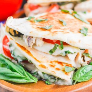 Chicken Caprese Quesadillas are an easy meal that comes together in minutes. With shredded chicken, fresh mozzarella, tomatoes and basil, this dish is kid-friendly and perfect for just about any time! #quesadillas #chicken #chickenquesadilla #caprese #capresequesadilla #chickendinner #dinner #recipe