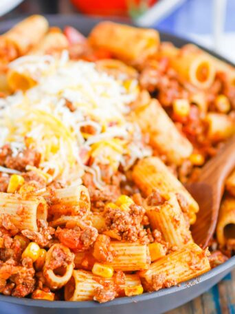 There is no better comfort food than this Chili with Pasta skillet meal. A comforting combination of ground beef, tomatoes, corn, and pasta come together with the perfect homemade chili seasoning to create an all in one meal you’ll love! #chili #chilipasta #chilipastaskillet #skilletdinner #pasta #easydinner #dinner #comfortfood