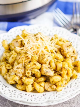 Instant Pot Pesto Chicken with Pasta is a delicious weeknight meal that combines the bright basil and garlic flavor of pesto with easy to cook chicken and pasta. The entire meal made in your Instant Pot in a little more than 30 minutes makes this a perfect weeknight recipe! #chicken #pestochicken #pesto #pestochickenpasta #pasta #instantpot #instantpotchicken #instantpotpasta #weeknightdinner #easydinner #dinner