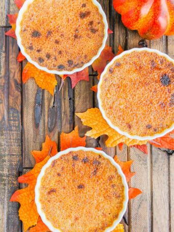 Pumpkin Crème Brûlée features a smooth and creamy custard that's studded with hints of pumpkin and the most delicious caramelized topping. Easy to make, this decadent dessert captures the flavors of fall and is sure to impress everyone! #cremebrulee #pumpkin #pumpkincremebrulee #cremebruleerecipe #falldessert #pumpkindessert #fancydessert