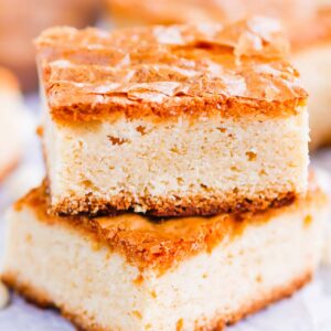 This White Chocolate Blondies Recipe combines the elegance of white chocolate with rich vanilla to bring you a delightfully sweet treat that is ready for the oven in minutes and baked in just half an hour.  Serve this recipe with a hot cup of coffee for the perfect treat on a cold day! #blondies #whitechocolate #whitechocolateblondies #blondierecipe #whitechocolatedessert #dessert #easydessert