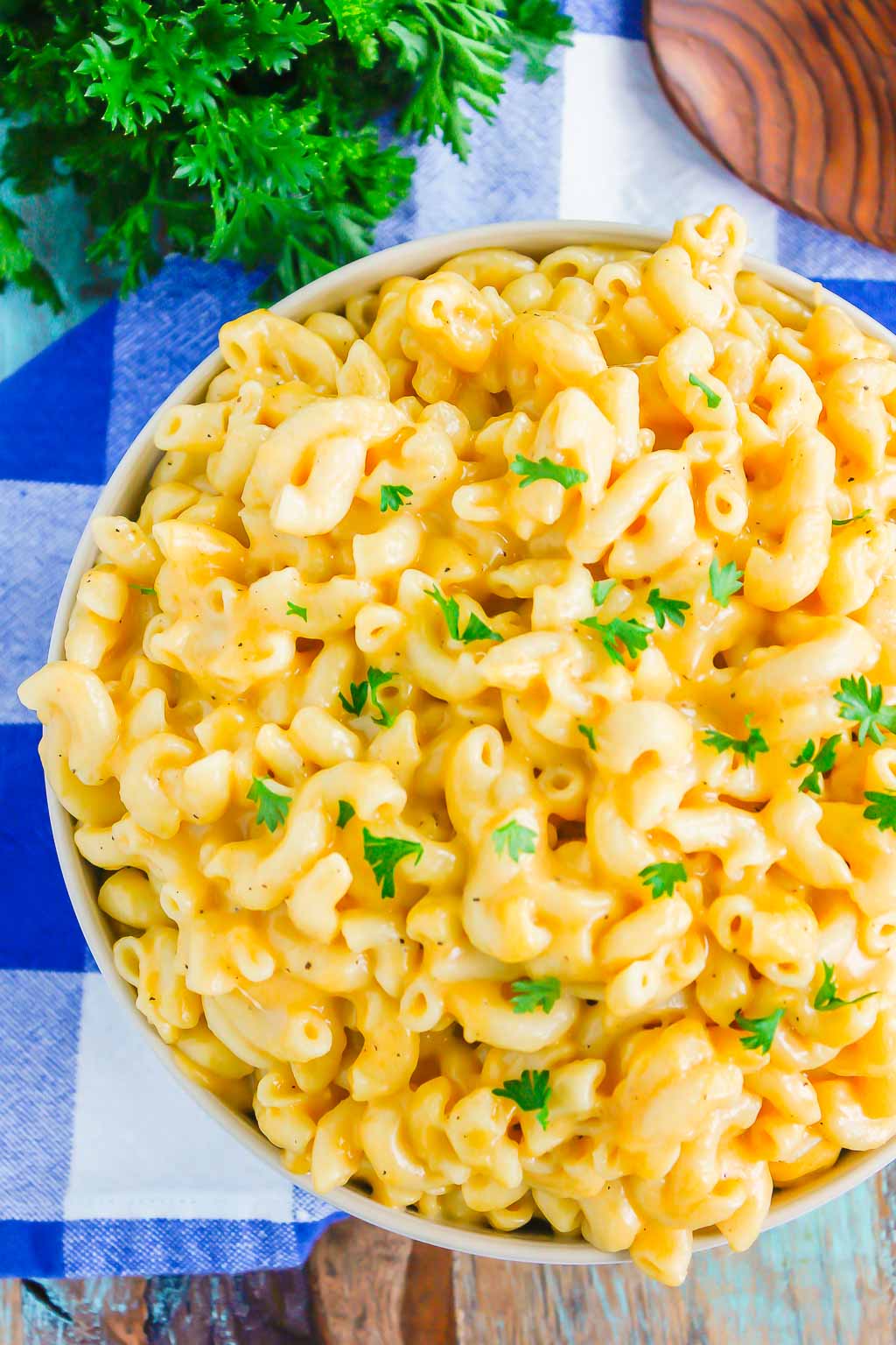 overhead view of instant pot mac and cheese in serving bowl on gingham towel