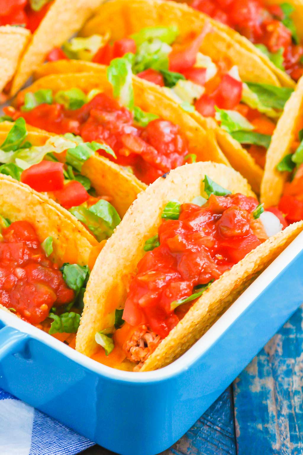 Oven baked chicken tacos in a blue baking dish 