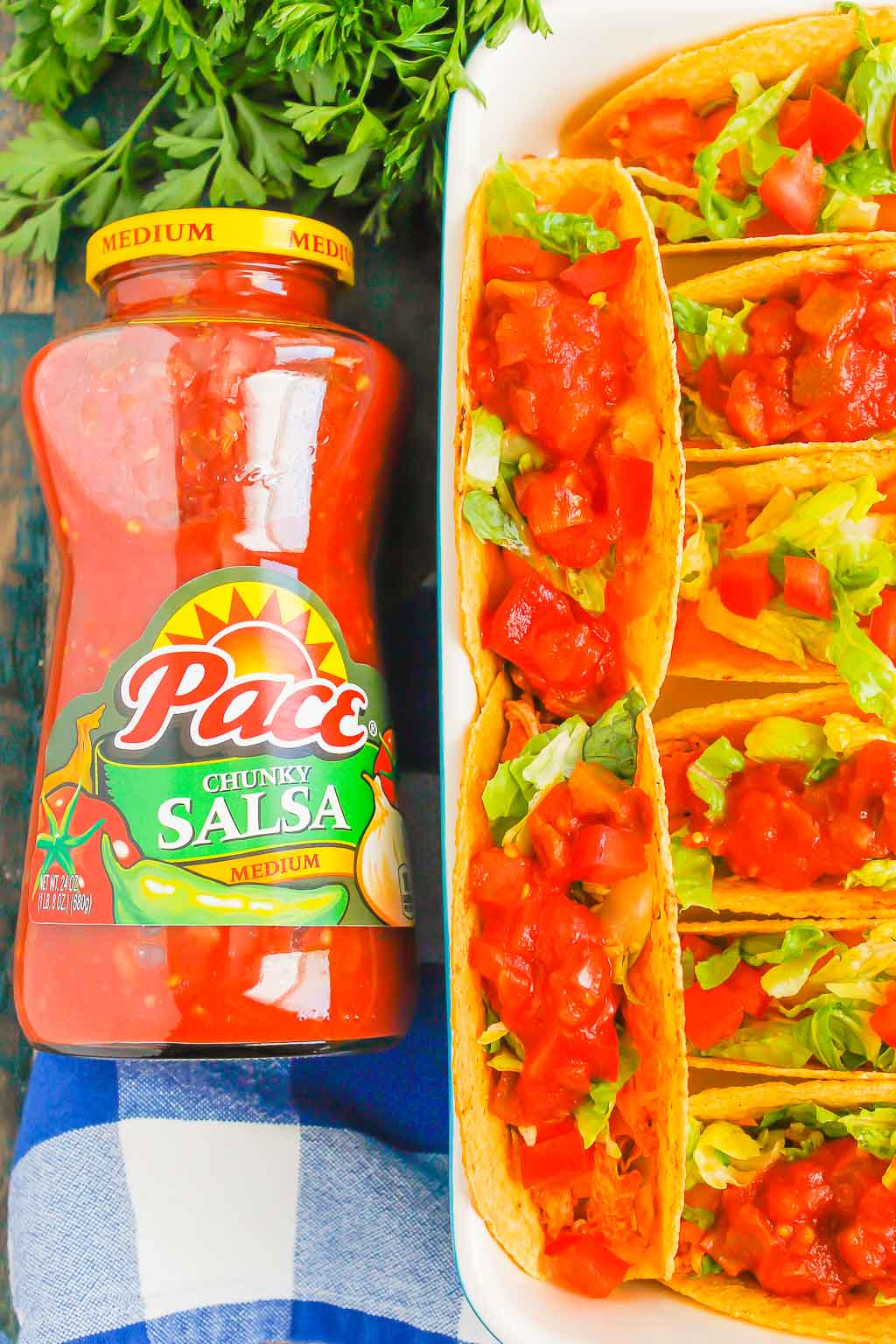 Overhead view of a jar of Pace salsa next to a pan of baked chicken tacos 