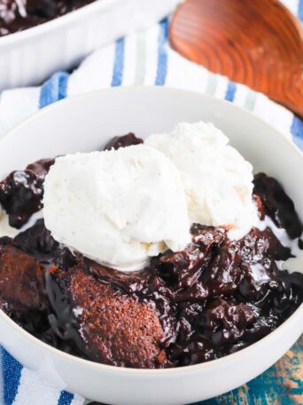 Chocolate Cobbler is a deliciously decadent dessert that's ready in no time. With a brownie like topping and a rich, fudgy sauce on the bottom, this dish tastes like molten lava cake, but in cobbler form! #cobbler #chocolate #chocolatecobbler #chocolatedessert #lavacake #dessert