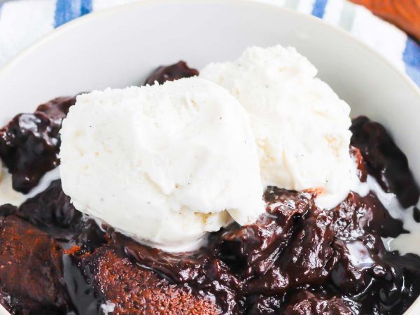 Chocolate Cobbler is a deliciously decadent dessert that's ready in no time. With a brownie like topping and a rich, fudgy sauce on the bottom, this dish tastes like molten lava cake, but in cobbler form! #cobbler #chocolate #chocolatecobbler #chocolatedessert #lavacake #dessert