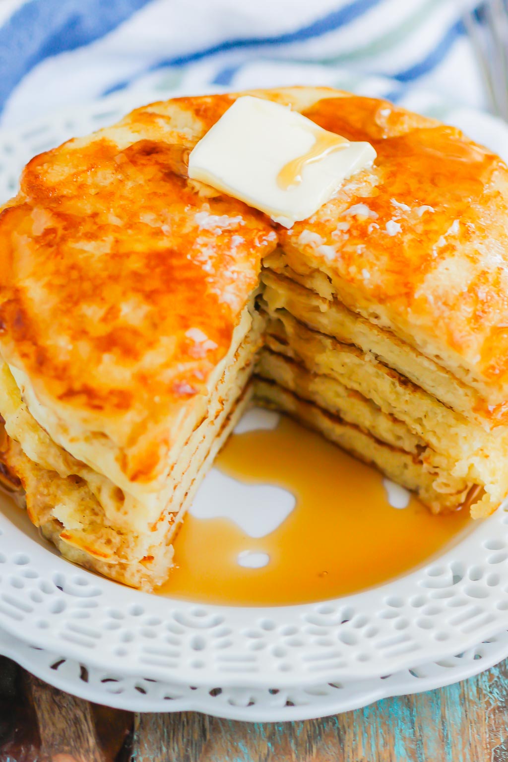 stack of homemade buttermilk pancakes with chunk missing