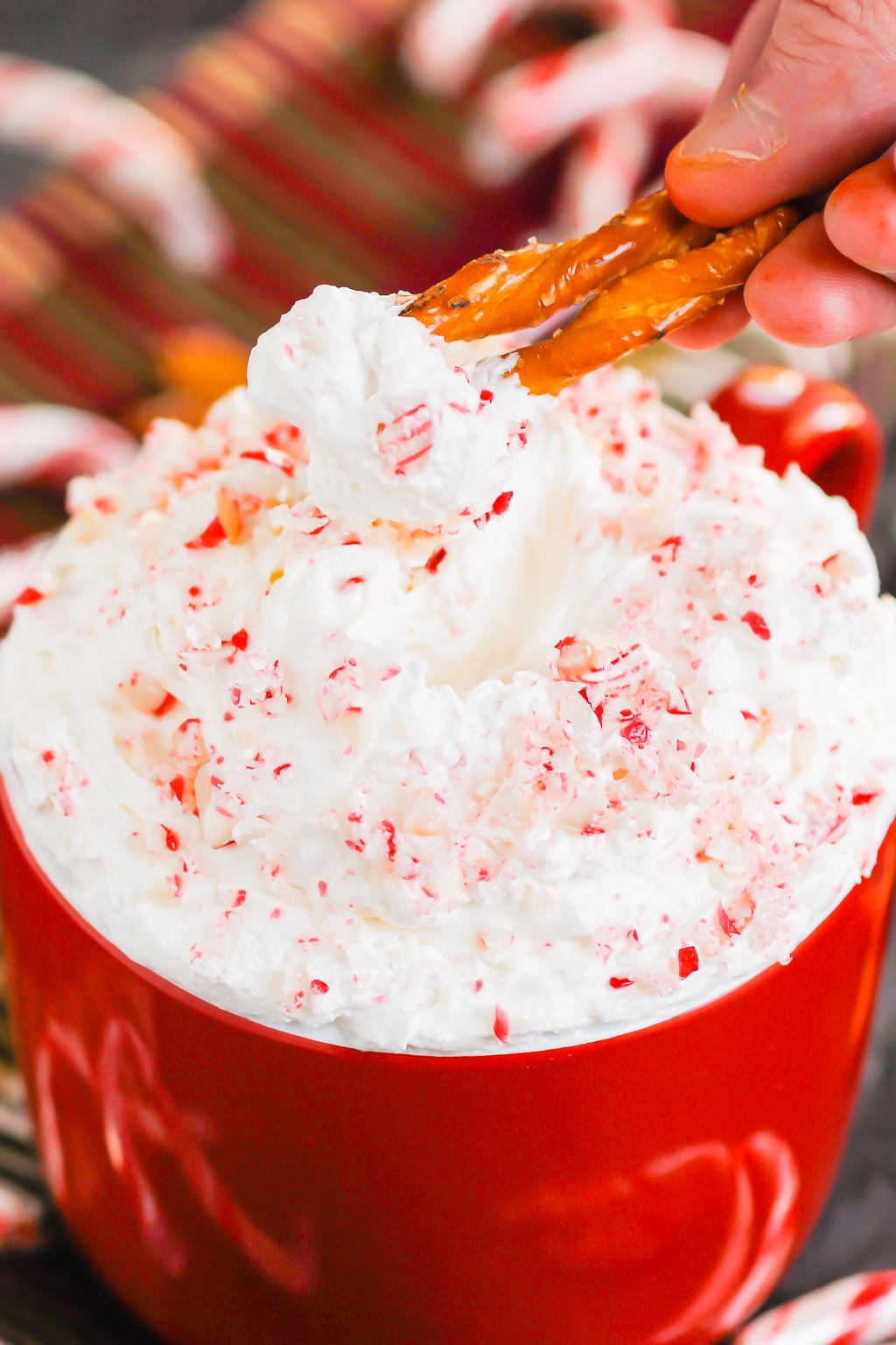 You're going to fall in love with how easy and delicious this Peppermint Cheesecake Dip recipe is to make. Itâ€™s a bright and refreshing dessert option for your holiday table. This treat mixes up in minutes and will be a hit with everyone! #peppermint #peppermintdip #peppermintcheesecake #peppermintcheesecakedip #candycanedip #dessert #christmasdessert #holidaydessert