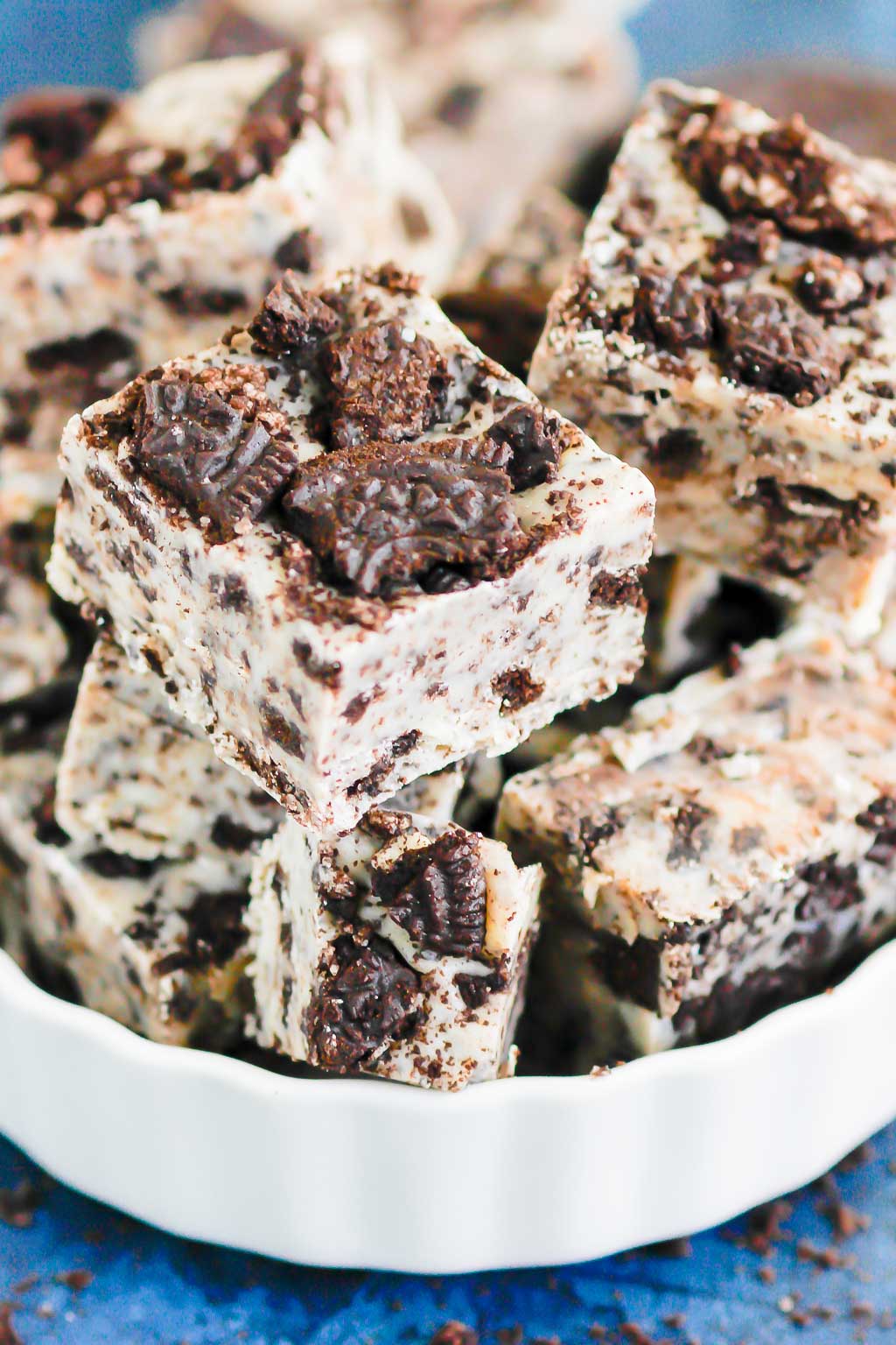 cookies and cream fudge stacked in a white serving dish 