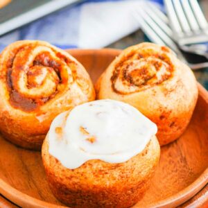 These Easy Pumpkin Cinnamon Rolls are a fun twist on the classic kind and ready in just 30 minutes. Filled with sweet pumpkin, cozy spices and topped with the most delicious cinnamon cream cheese frosting, these rolls are perfect for breakfast or dessert! #cinnamonrolls #cinnamonrollrecipe #pumpkin #pumpkincinnamonrolls #pumpkinbreakfast #pumpkindessert #dessertrecipes #breakfastrecipes #fallrecipes #breakfast #dessert