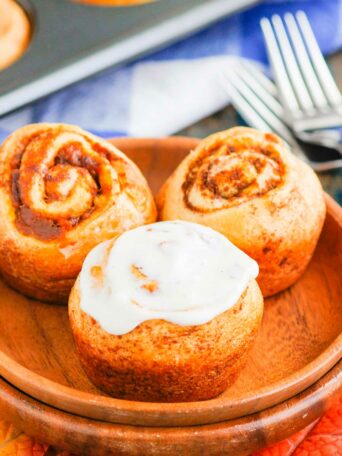 These Easy Pumpkin Cinnamon Rolls are a fun twist on the classic kind and ready in just 30 minutes. Filled with sweet pumpkin, cozy spices and topped with the most delicious cinnamon cream cheese frosting, these rolls are perfect for breakfast or dessert! #cinnamonrolls #cinnamonrollrecipe #pumpkin #pumpkincinnamonrolls #pumpkinbreakfast #pumpkindessert #dessertrecipes #breakfastrecipes #fallrecipes #breakfast #dessert