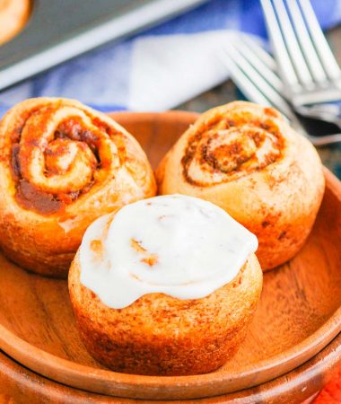 These Easy Pumpkin Cinnamon Rolls are a fun twist on the classic kind and ready in just 30 minutes. Filled with sweet pumpkin, cozy spices and topped with the most delicious cinnamon cream cheese frosting, these rolls are perfect for breakfast or dessert! #cinnamonrolls #cinnamonrollrecipe #pumpkin #pumpkincinnamonrolls #pumpkinbreakfast #pumpkindessert #dessertrecipes #breakfastrecipes #fallrecipes #breakfast #dessert