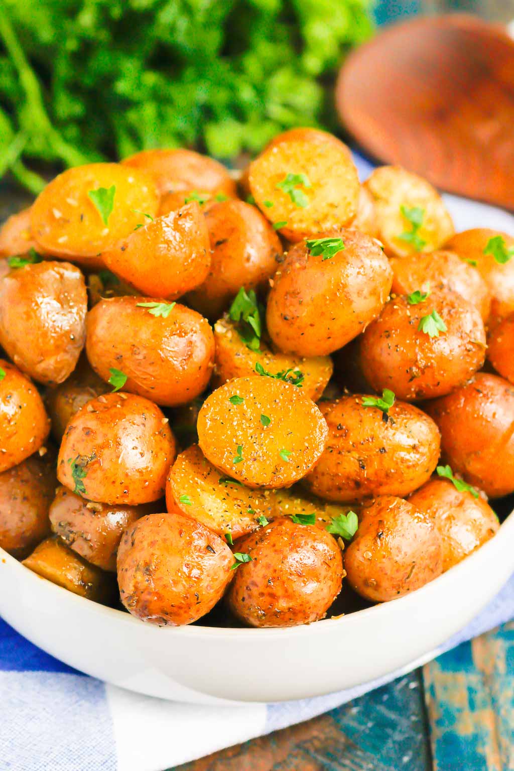 white serving dish piled high with instant pot red potatoes