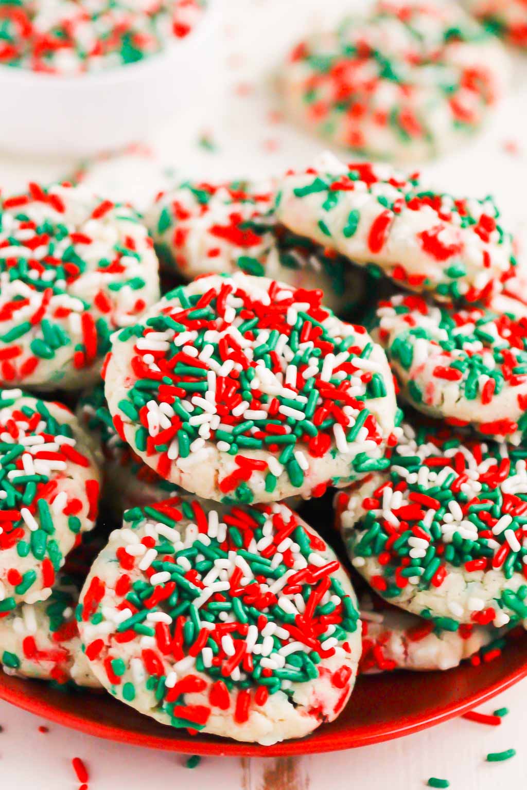 a plate of sugar cookies with sprinkles. 
