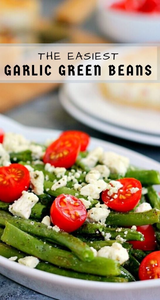 Roasted Garlic Green Beans are filled with fresh beans, ripe tomatoes and feta cheese, combined with a light garlic and lemon dressing! #greenbeans #greenbeanrecipe #roastedgreenbeans #vegetables #roastedvegetables #sidedish #easysidedish