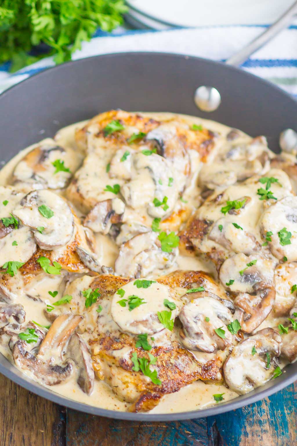 creamy parmesan garlic mushroom chicken in a skillet 