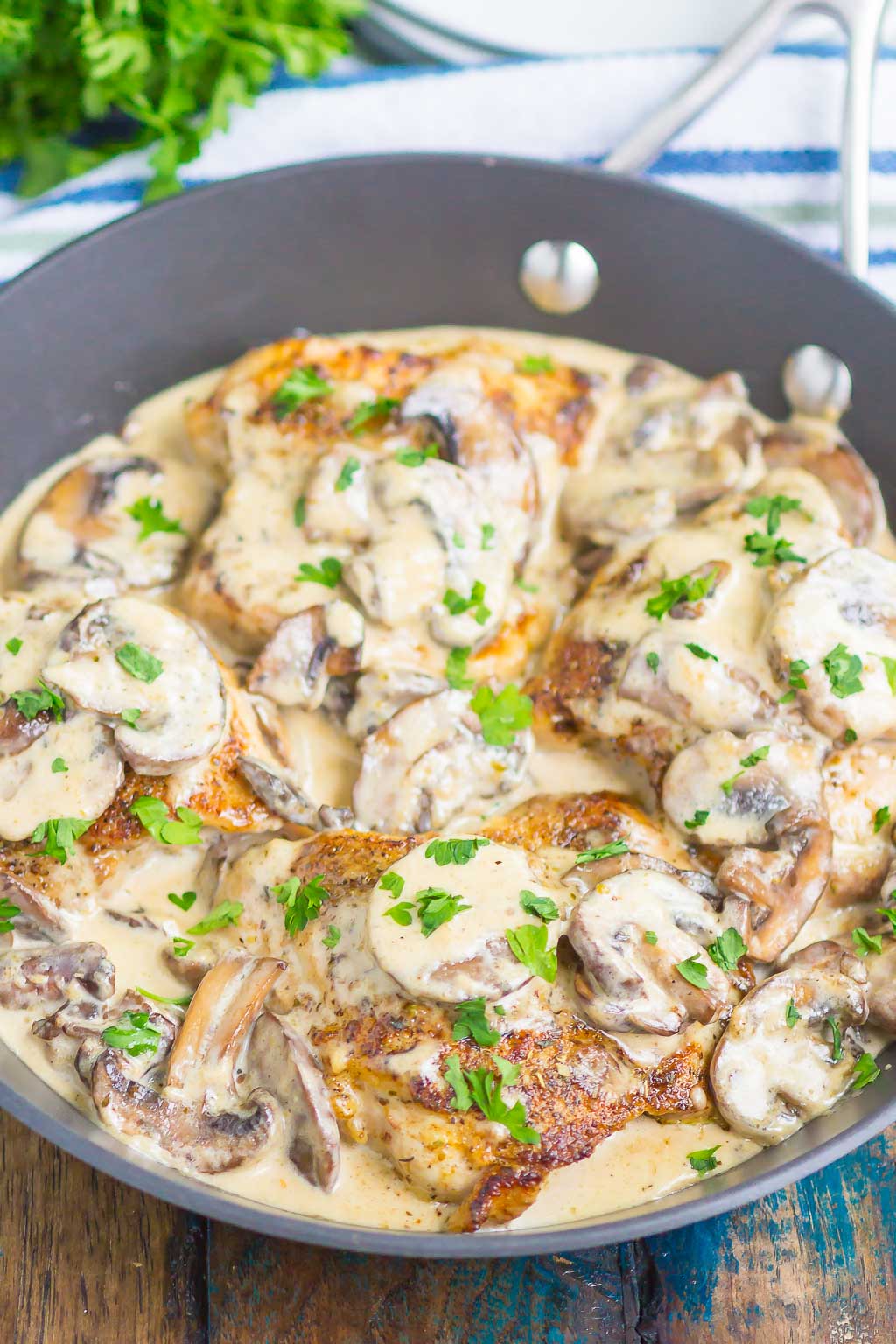 creamy parmesan chicken with mushroom sauce in a skillet 