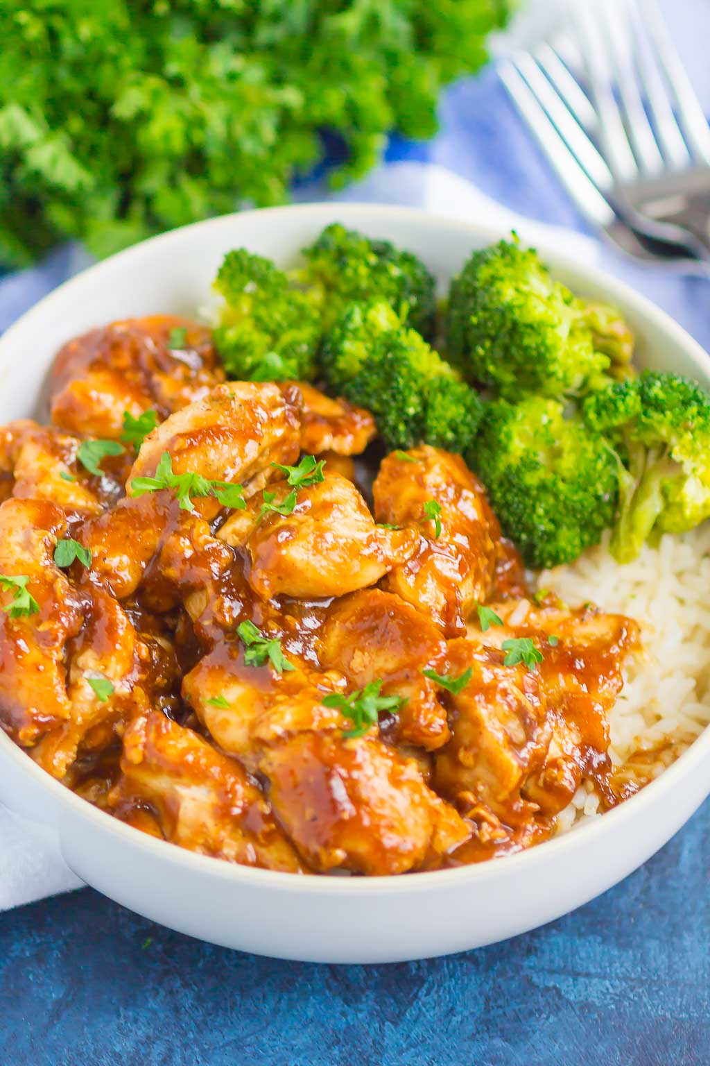 A white bowl with homemade teriyaki chicken, white rice, and broccoli. 