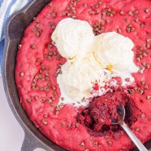 Red Velvet Skillet Cookie is thick and chewy, with a warm, gooey center. Baked in a skillet and topped with chocolate chips, you'll want to dig in with a big scoop of vanilla ice cream!