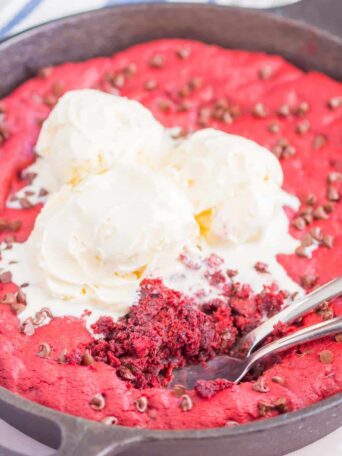 Red Velvet Skillet Cookie is thick and chewy, with a warm, gooey center. Baked in a skillet and topped with chocolate chips, you'll want to dig in with a big scoop of vanilla ice cream!