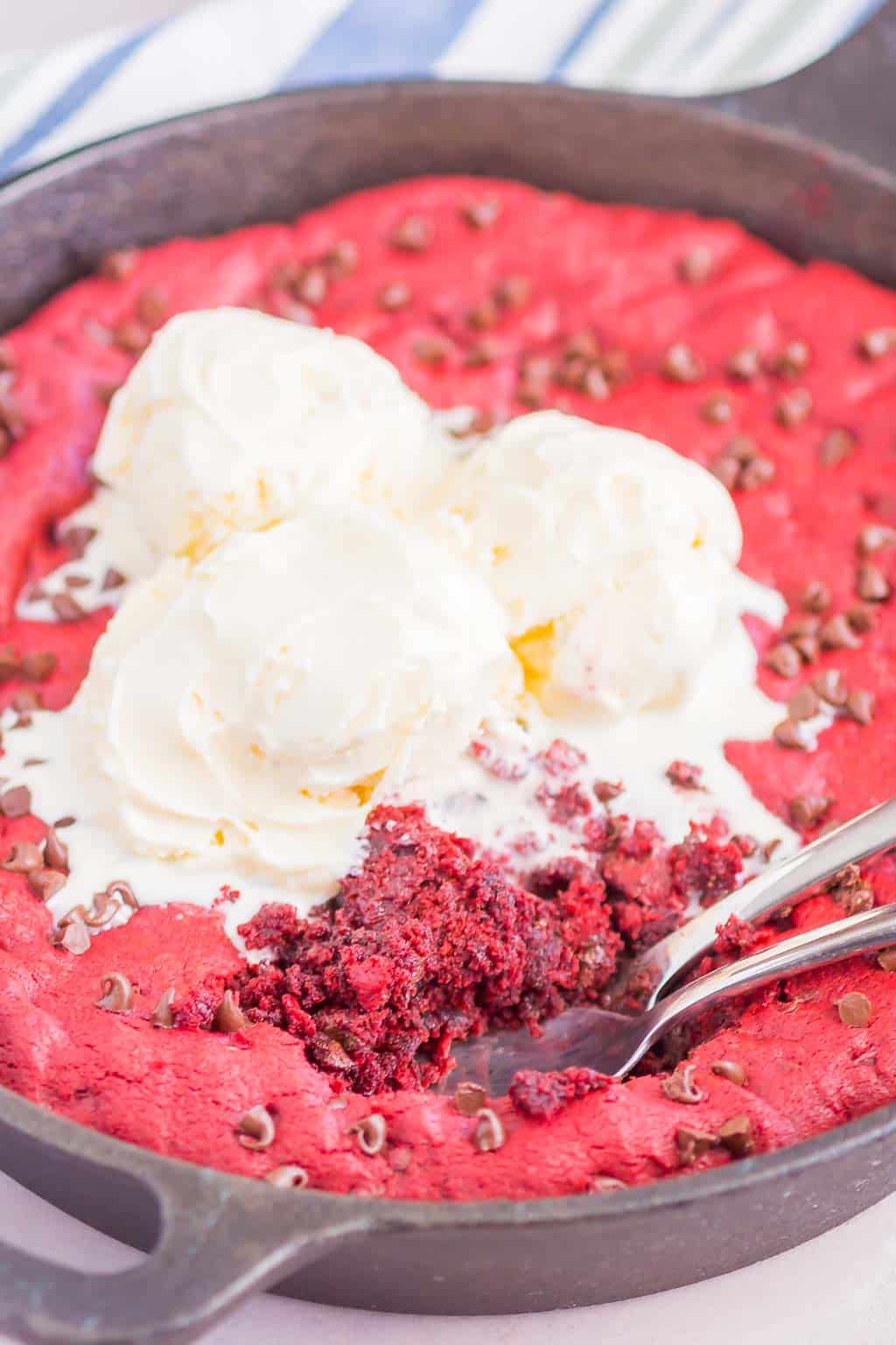 Red Velvet Skillet Cookie is thick and chewy, with a warm, gooey center. Baked in a skillet and topped with chocolate chips, you'll want to dig in with a big scoop of vanilla ice cream!