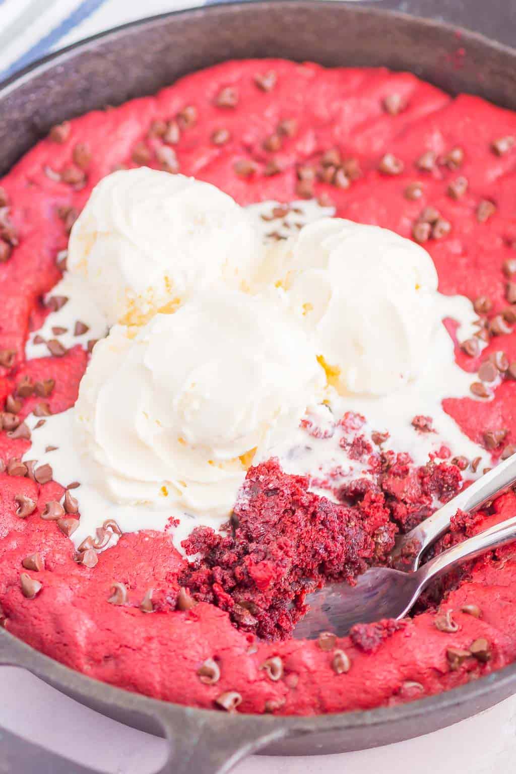 Red Velvet Skillet Cookie is thick and chewy, with a warm, gooey center. Baked in a skillet and topped with chocolate chips, you'll want to dig in with a big scoop of vanilla ice cream!