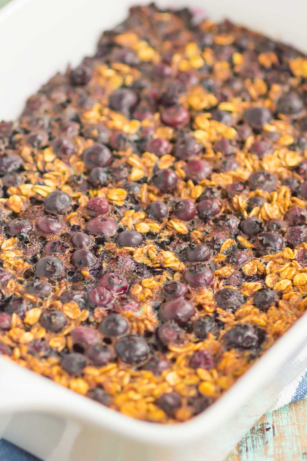 Blueberry Baked Oatmeal is an easy, make-ahead dish that's perfect for busy mornings. Tangy blueberries and hearty oats are sweetened with just the right amount of cozy spices. Serve this baked oatmeal with a drizzle of honey or maple syrup for a hearty breakfast!