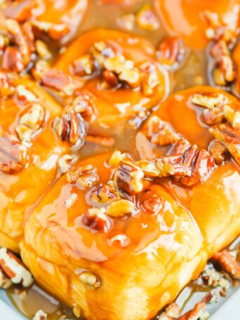 Caramel Sticky Buns are soft, sweet, and ready in just 30 minutes. Sweet rolls are topped with a rich caramel sauce, chopped pecans, and then baked until golden. Perfect for breakfast or dessert! #stickybuns #sweetrolls #caramelstickybuns #caramelrolls #breakfast #dessert