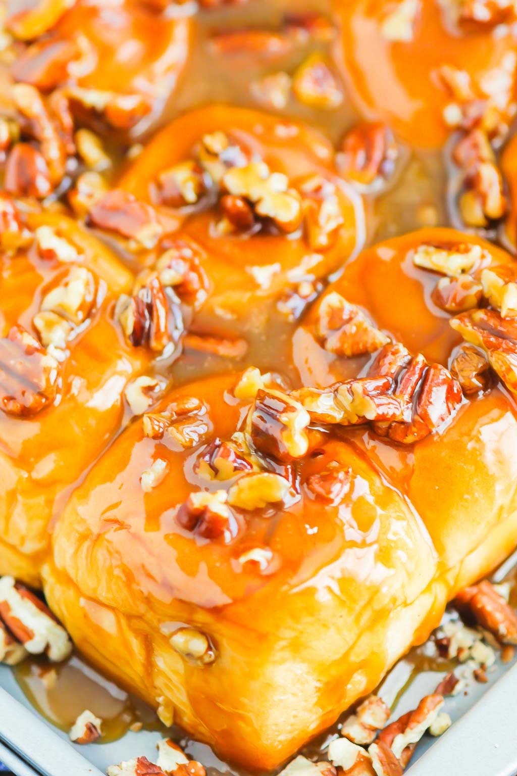 Caramel Sticky Buns are soft, sweet, and ready in just 30 minutes. Sweet rolls are topped with a rich caramel sauce, chopped pecans, and then baked until golden. Perfect for breakfast or dessert! #stickybuns #sweetrolls #caramelstickybuns #caramelrolls #breakfast #dessert