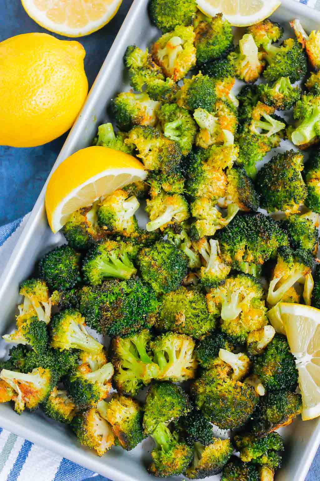 overhead view of roasted garlic lemon broccoli on a baking sheet 