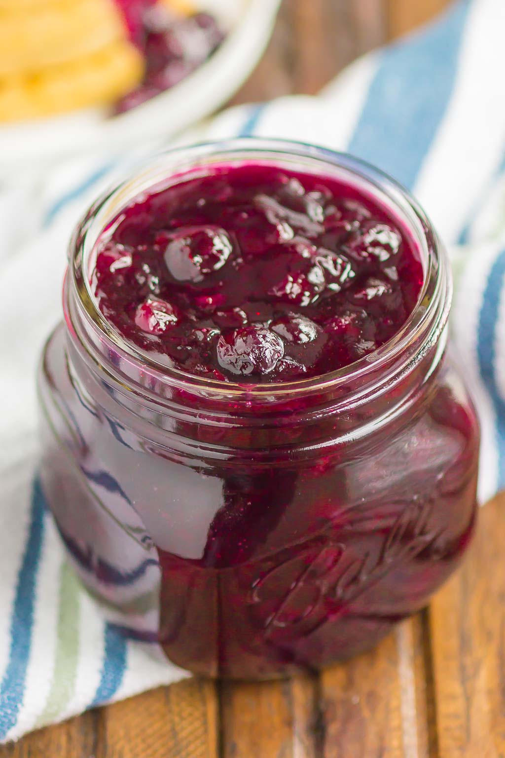 Homemade blueberry sauce in a small ball jar. 