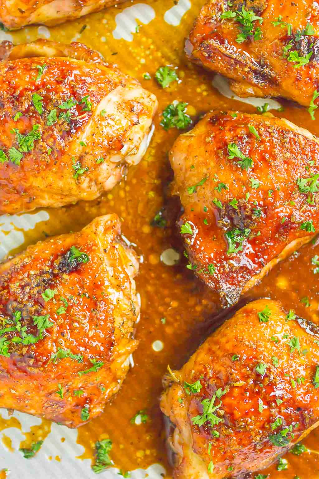 overhead view of balsamic chicken thighs on a baking tray