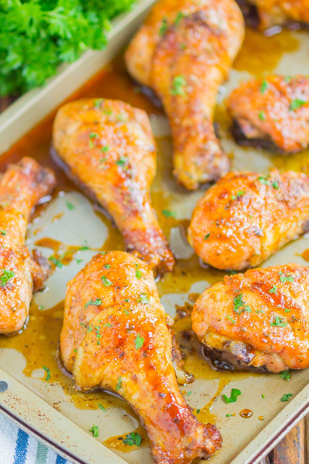 Baked chicken legs on a cookie sheet. 