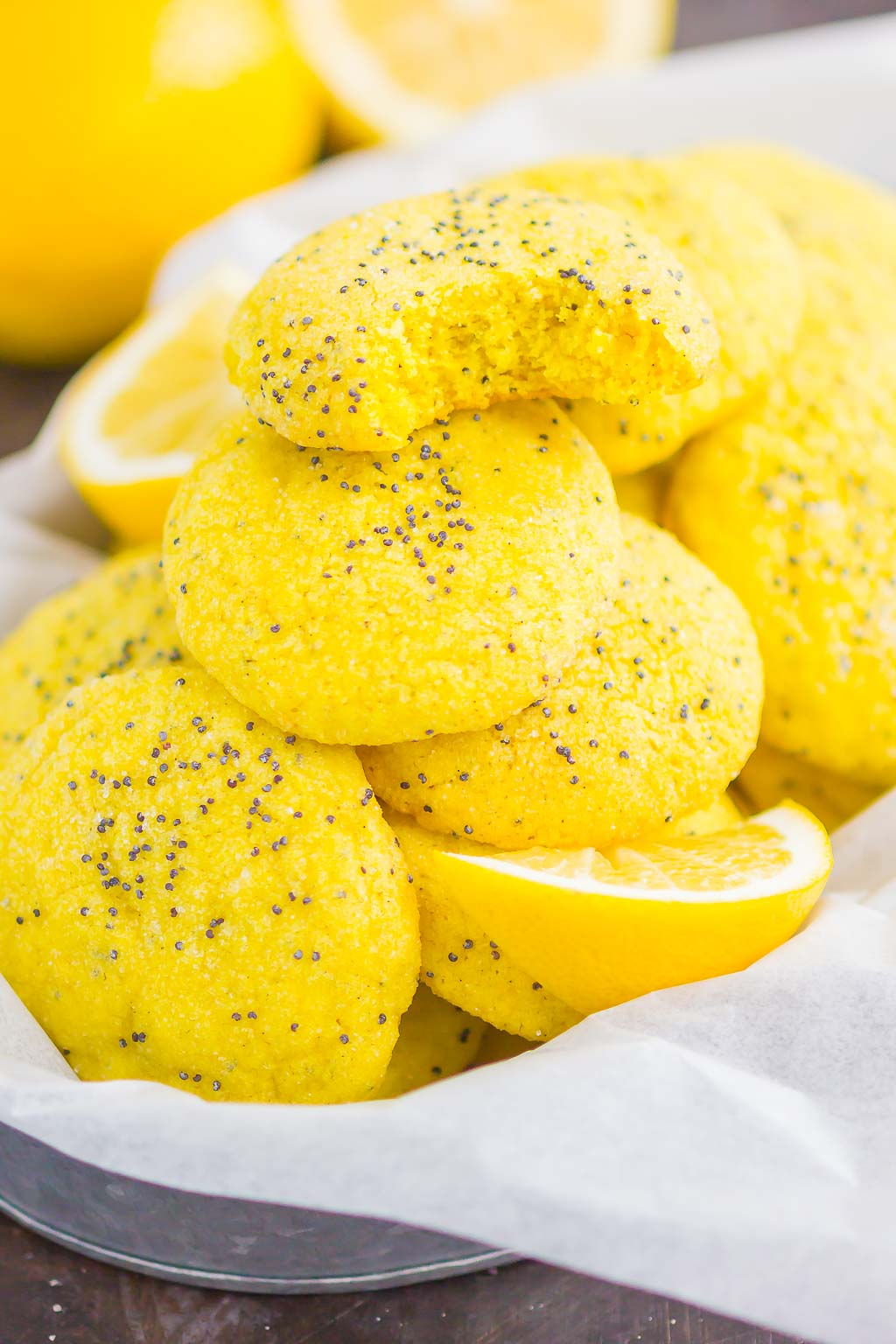 A pile of lemon poppy seed cookies in a metal basket. 